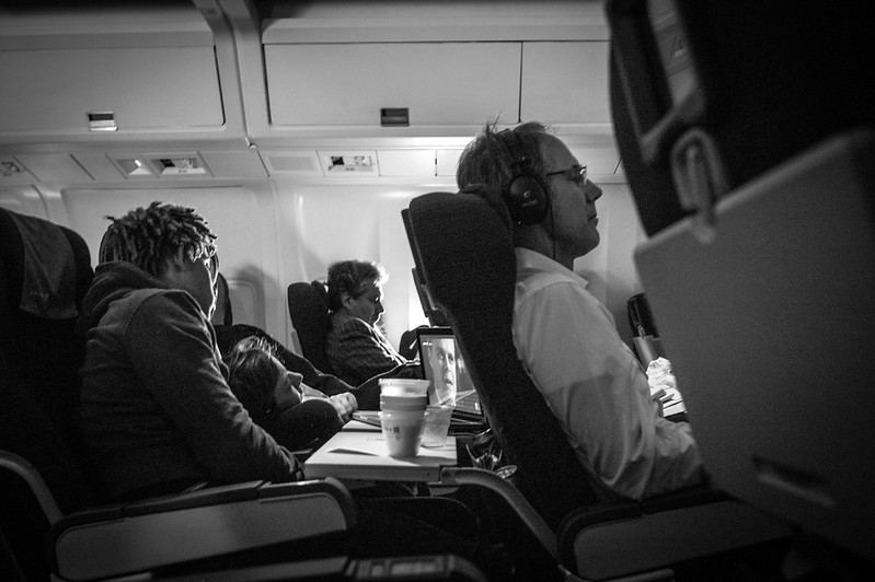 Strangers sharing technology on flight